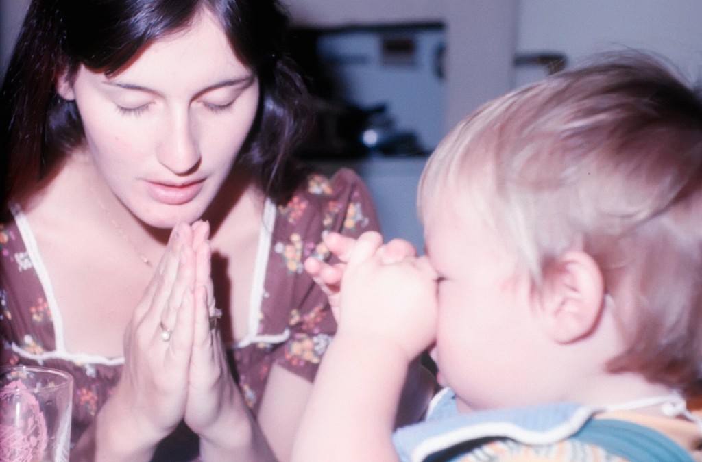 Christine Pearce praying with her baby